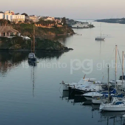 Mirando hacia el puerto al atardecer con algunos barcos en primer plano